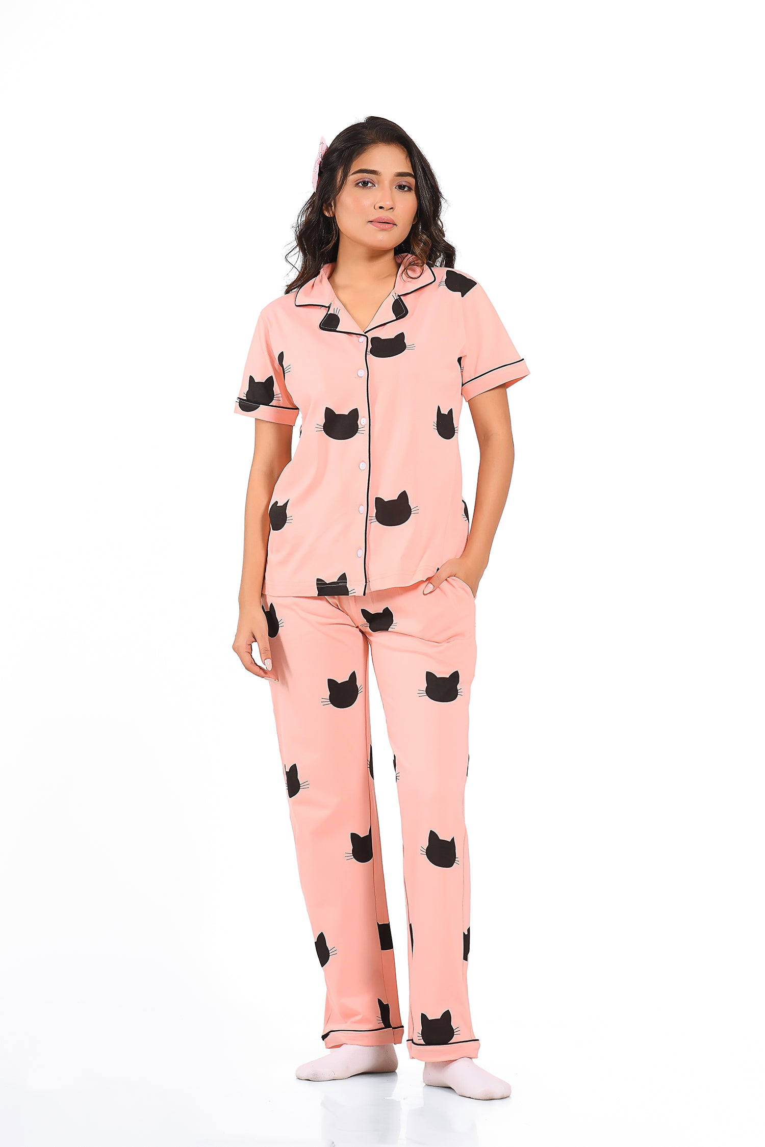 Young girl in a Pink Colour Kitty Printed Pyjama Set nightwear by NapStory, standing in style.