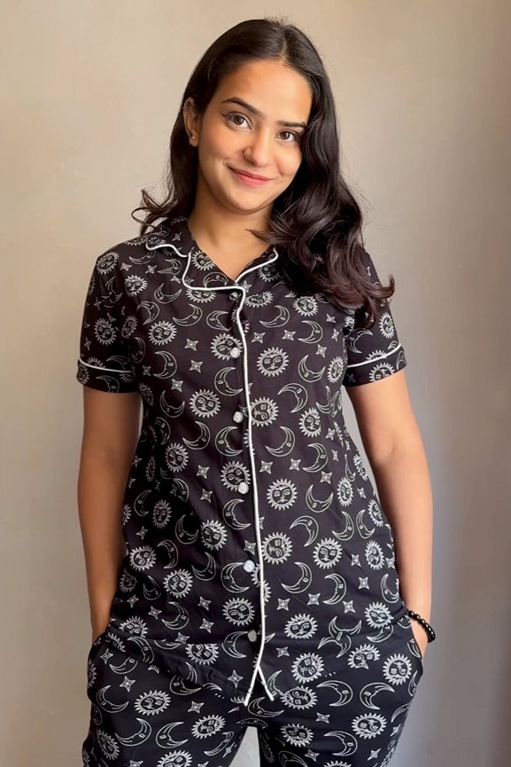 A girl in a black Star Moon Print Pyjama Set nightwear by NapStory