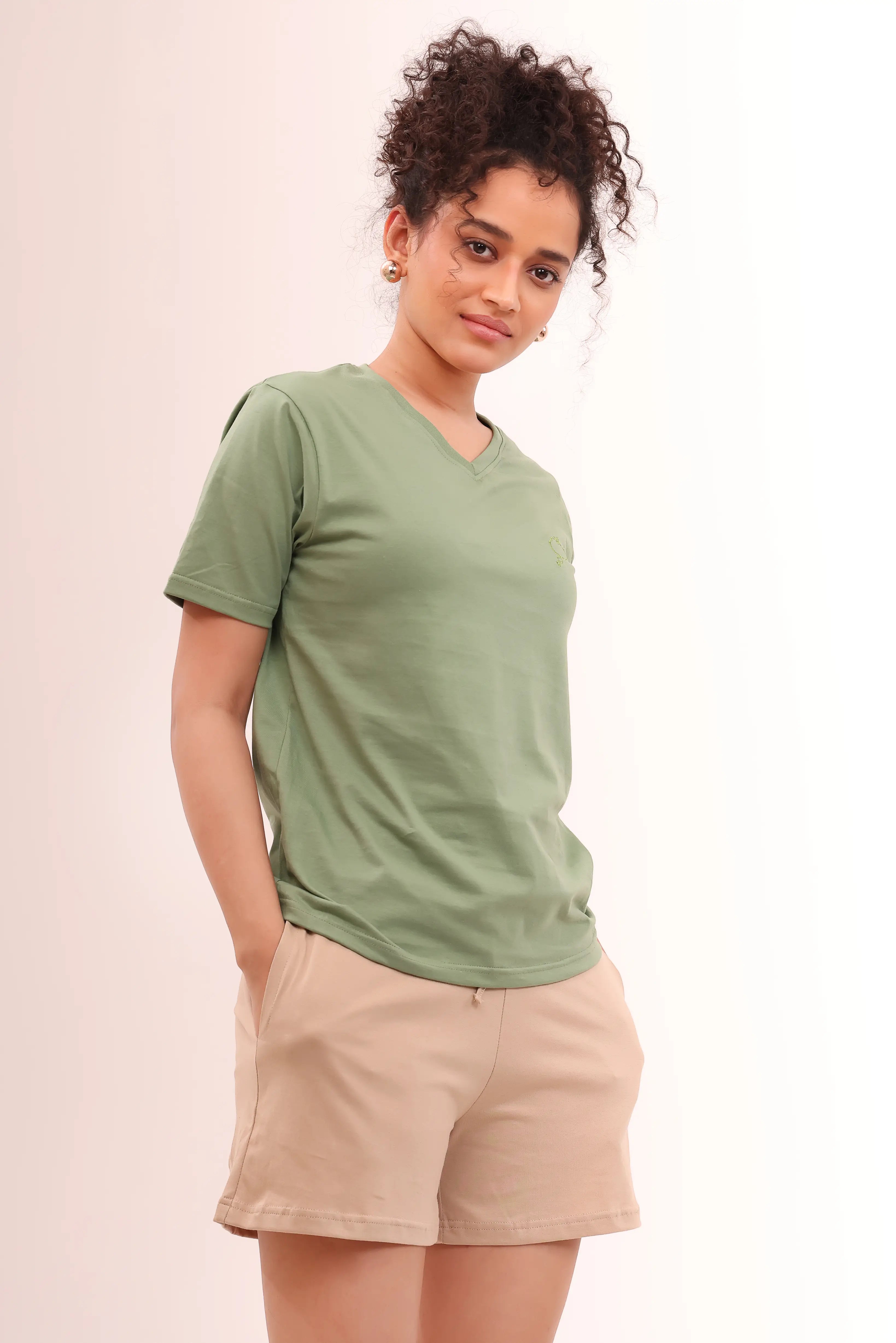 Woman posing in Leaf Green V-Neck Tee crafted in soft 100% cotton by NapStory