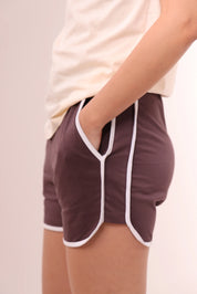 Close side view of brown piped-up shorts with white piping detail, loungewear by NapStory