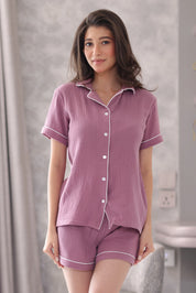 Woman wearing a muslin shorts set in a bathroom setting