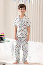 Child wearing a cloud-patterned pajama set in a living room setting