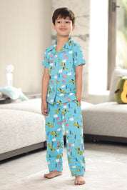 Child wearing blue pajamas with an animal pattern in a bedroom setting