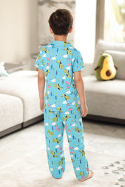 A child wearing a blue pajama set with animal prints in a living room.