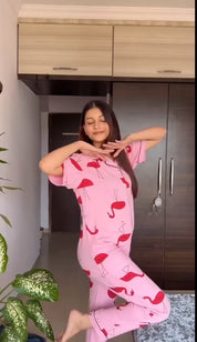 A young lady sitting in Flamingo print nightwear pyjama set - 100% cotton night suit.