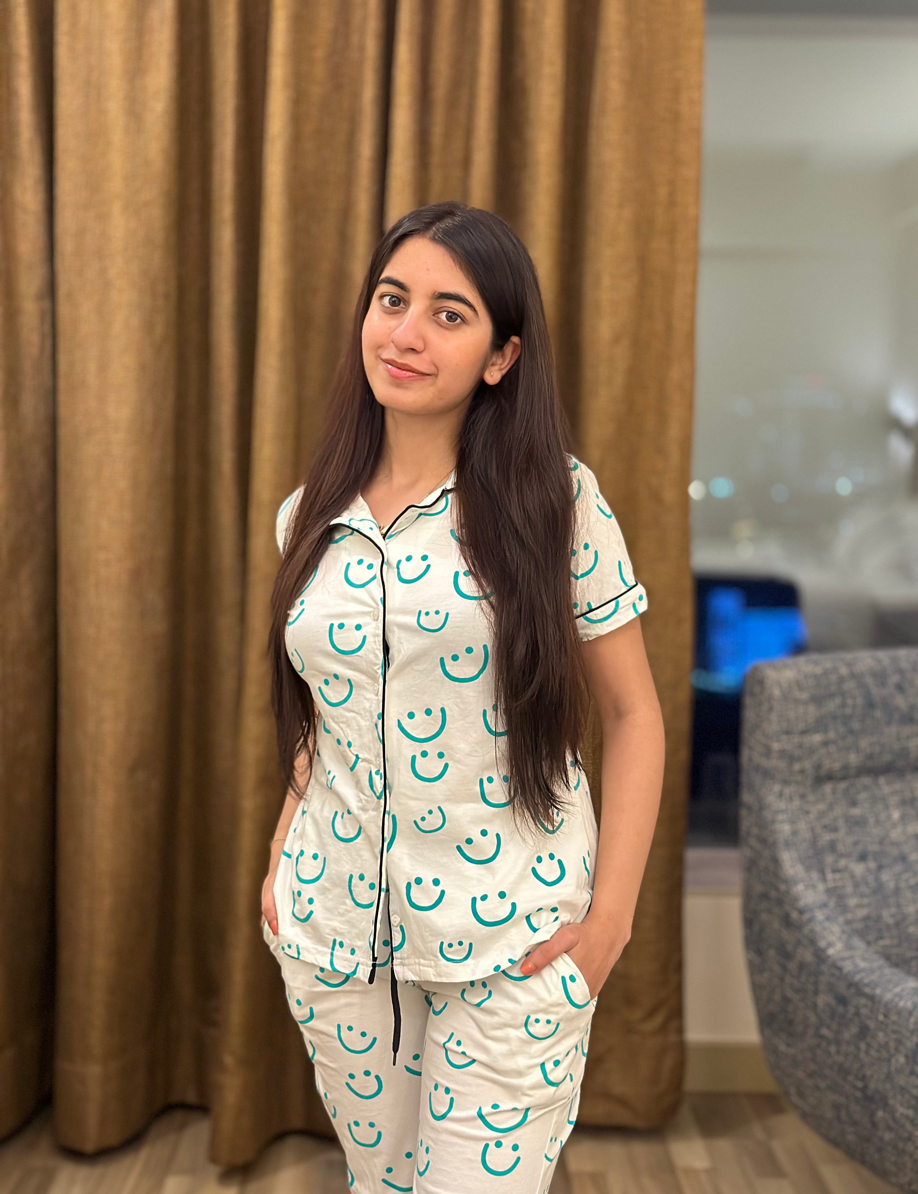 Girl in a Smiley Print Pyjama Set nightwear by NapStory, confidently standing with a stylish look.