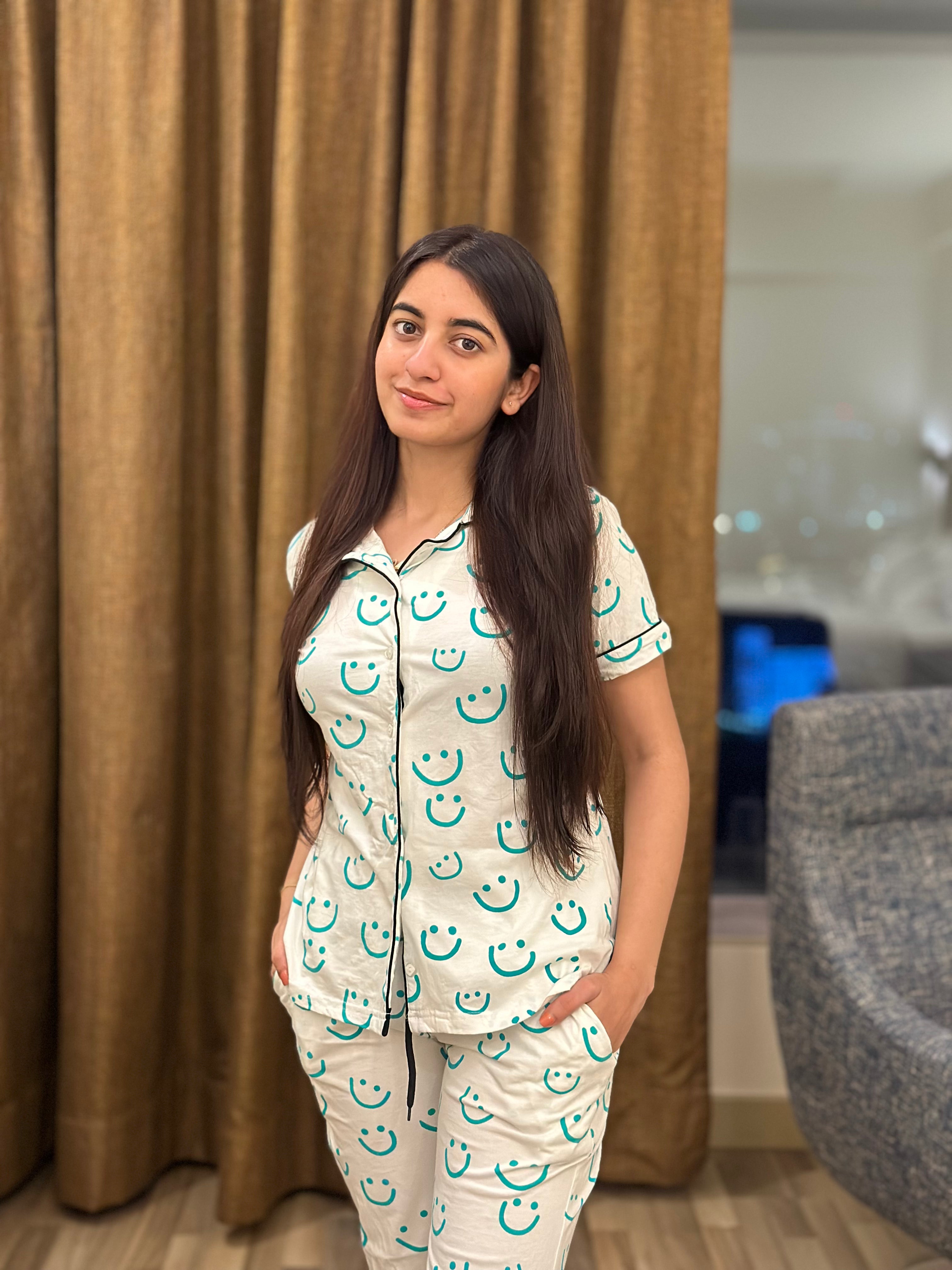 Girl in a Smiley Print Pyjama Set nightwear by NapStory, confidently standing with a stylish look.