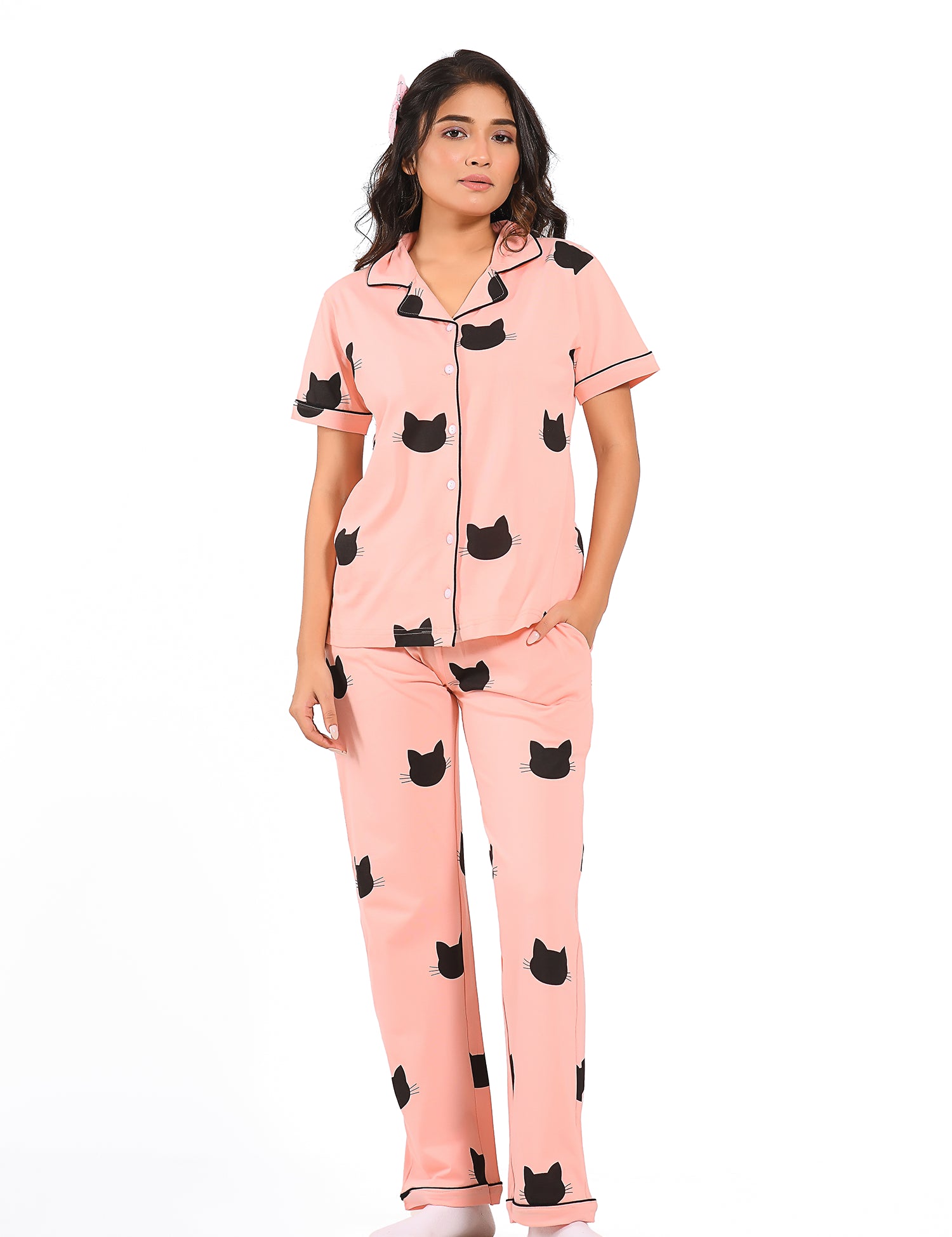 Young girl in a Pink Colour Kitty Printed Pyjama Set nightwear by NapStory, standing in style.