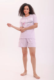 Woman posing in lavender oversized printed tee and shorts, a perfect loungewear by NapStory