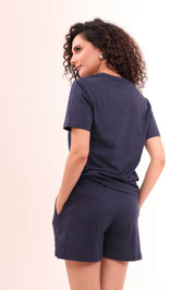 Back view of woman wearing Basic Navy V-Neck Tee crafted from 100% cotton by NapStory