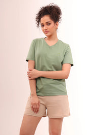 Lady standing in Basic Leaf Green Cotton V-Neck Tee with short sleeves by NapStory