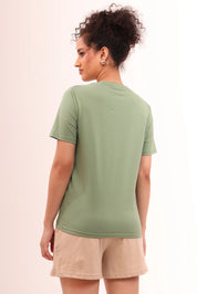 Back view of woman in Basic Leaf Green Cotton V-Neck Tee for everyday wear by NapStory