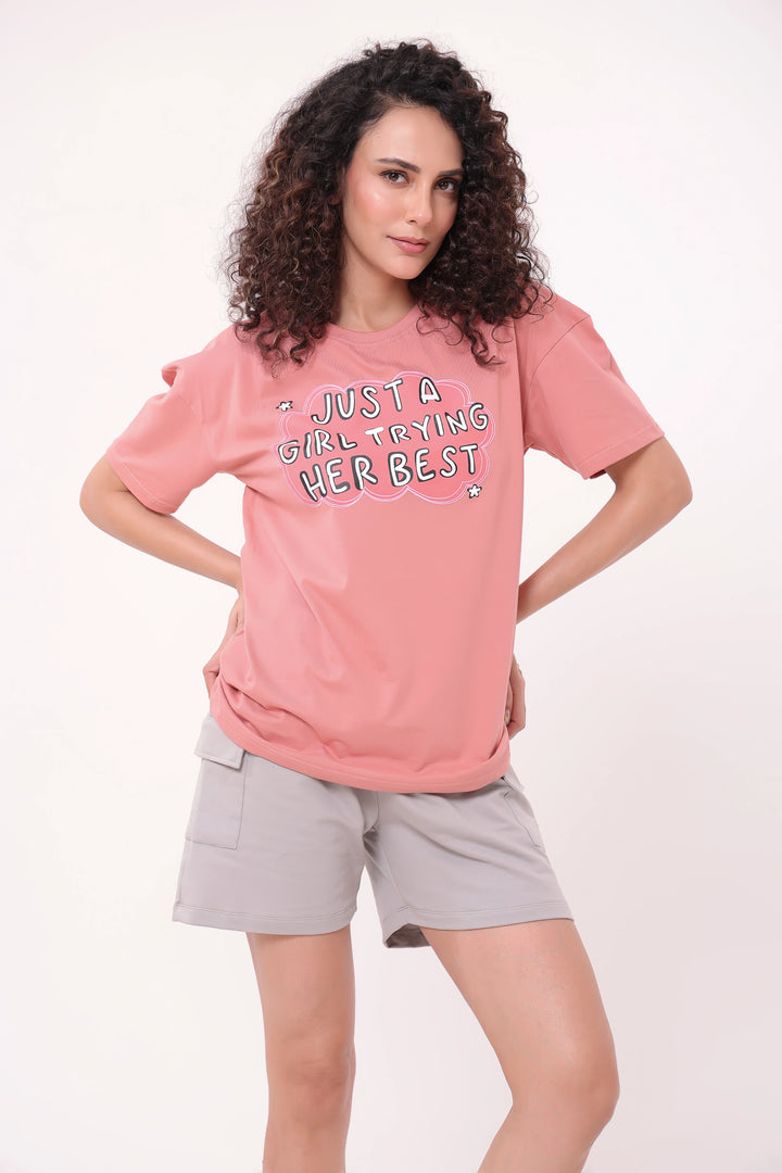 Woman standing with hands on waist wearing rose pink oversized tee and grey shorts lounge wear by NapStory
