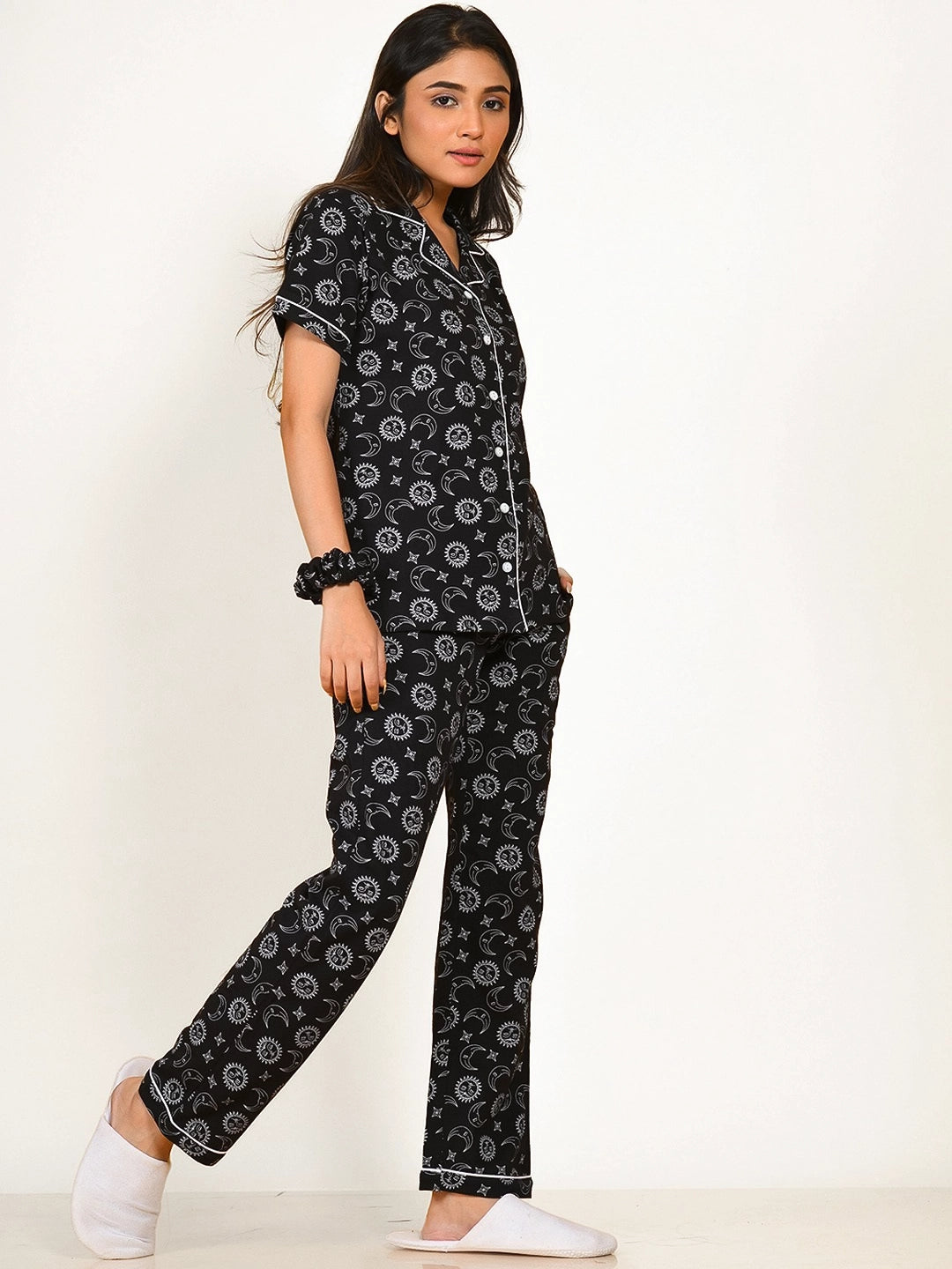 A girl in a black Star Moon Print Pyjama Set nightwear by NapStory