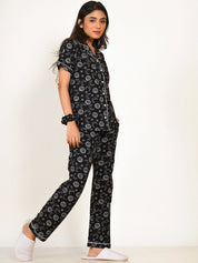 A girl in a black Star Moon Print Pyjama Set nightwear by NapStory