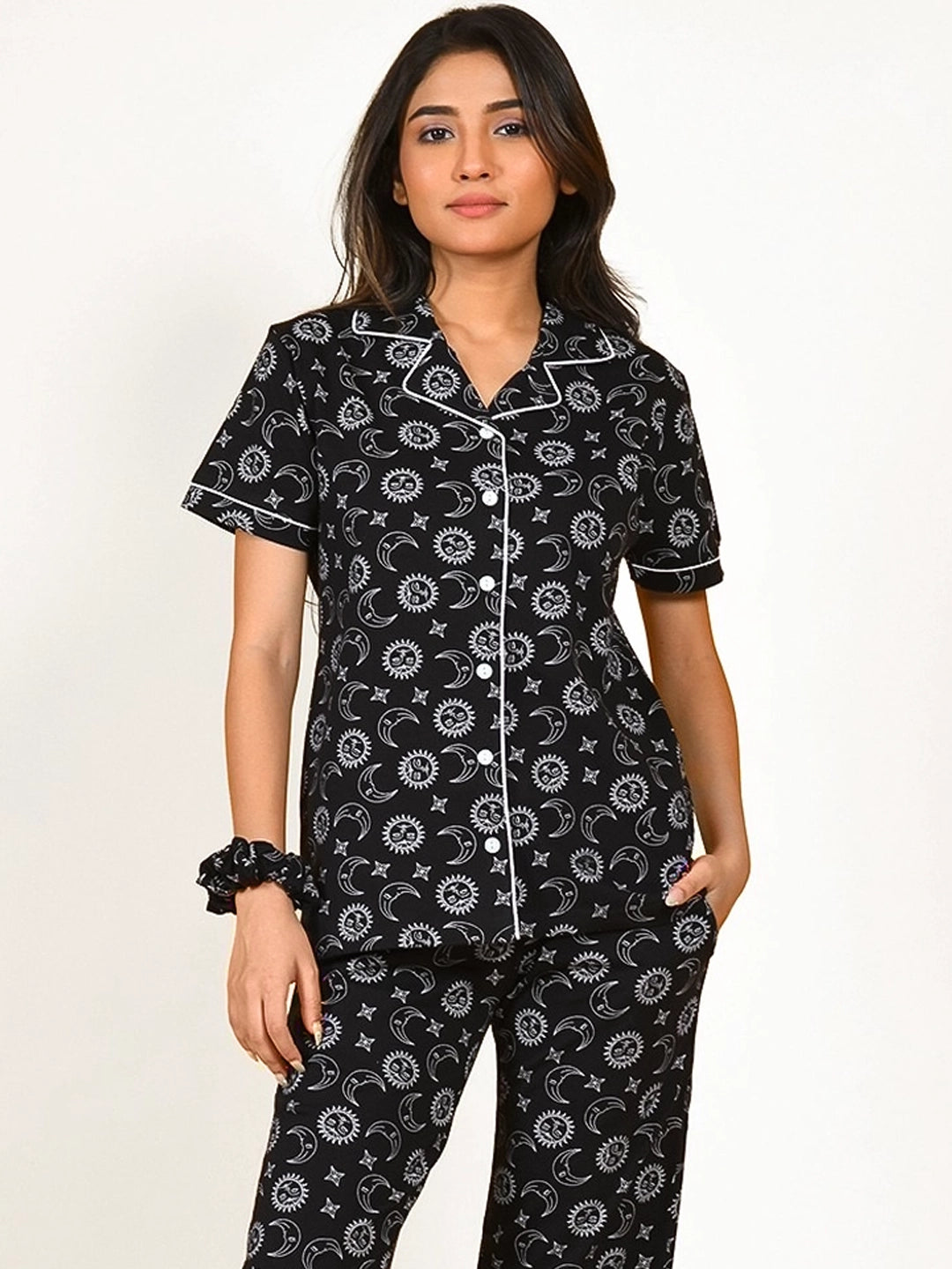 A girl in a black Star Moon Print Pyjama Set nightwear by NapStory
