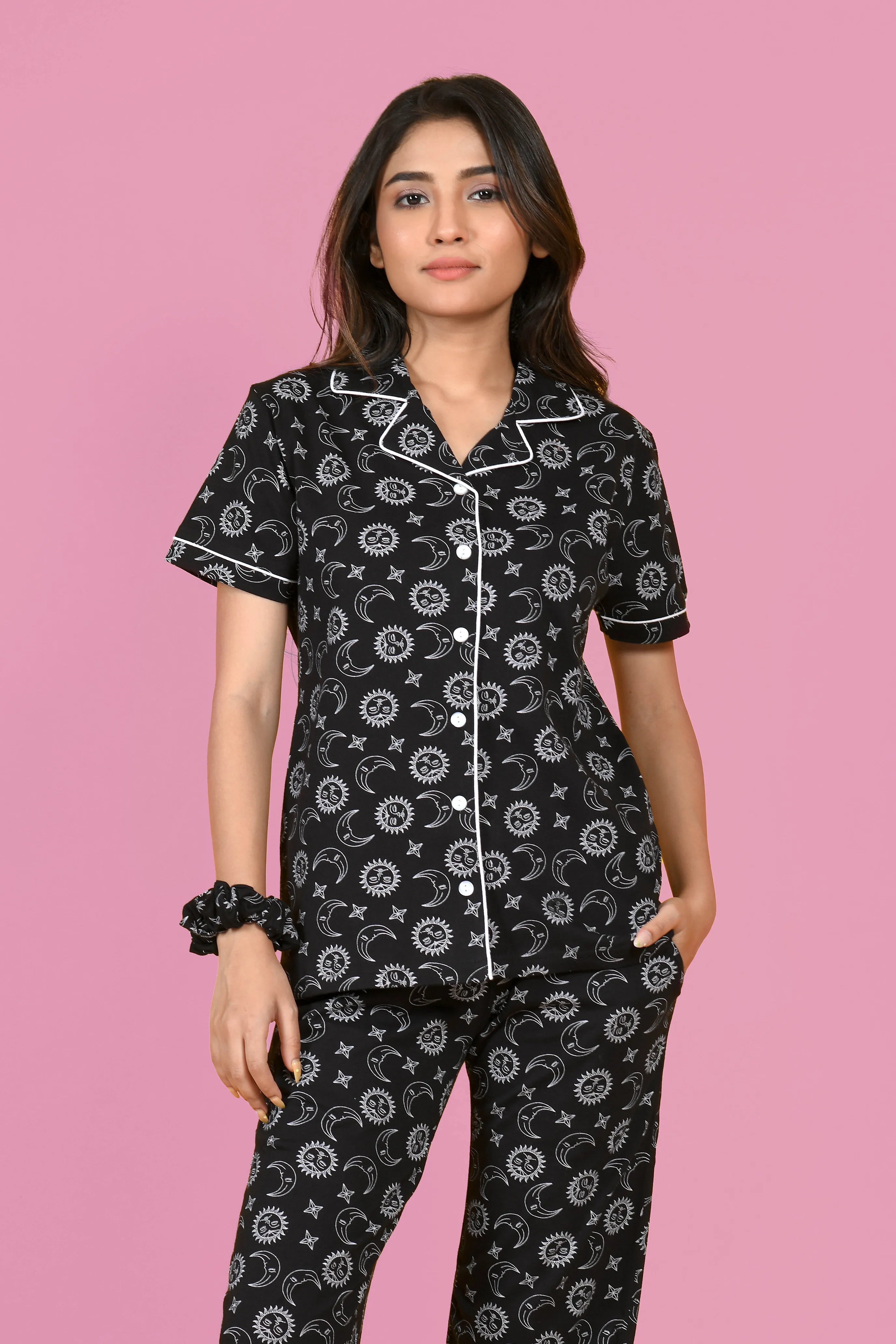 A girl in a black Star Moon Print Pyjama Set nightwear by NapStory